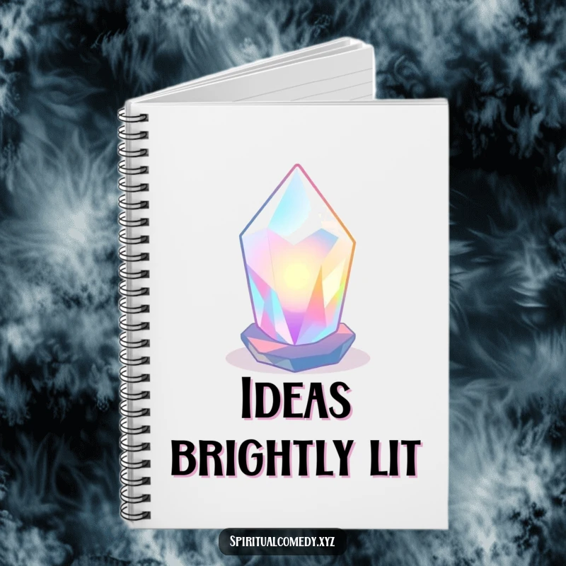 Funny notebook with a stylized, luminous crystal radiating soft colored light in a tranquil space, great for humorous journaling.
